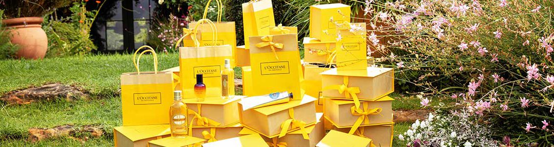 l'occitane yellow gift bags with best sellers on grass